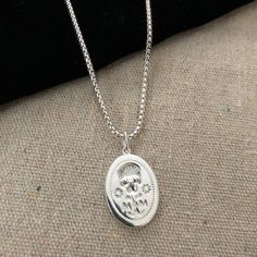 Our pendant was designed to follow our signet ring which is based on a Renaissance Memento Mori from 1600. Memento Mori jewelry has been worn for hundreds of years as a way to remember loved ones who have passed on. Worn on a sterling silver round box chain at 18" long with a 2" extension. All orders over $50 ship for free within the USA. All orders usually ship within 24 hours from the USA. Symbolic Oval Jewelry For Commemoration, Elegant Sterling Silver Jewelry For Commemoration, Elegant Silver Jewelry For Commemoration, Symbolic Sterling Silver Oval Jewelry, Sterling Silver Necklaces For Commemoration With Polished Finish, Antique Sterling Silver Oval Link Jewelry, Sterling Silver Necklaces With Polished Finish For Commemoration, Commemorative 925 Silver Round Pendant Jewelry, Sterling Silver Round Pendant Necklace For Commemoration