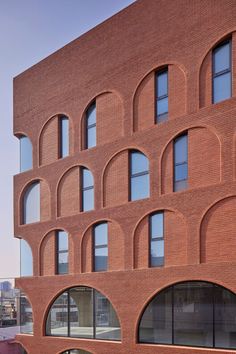 a brick building with arched windows on the side