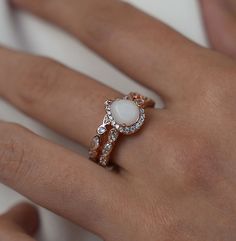 a woman's hand with a ring on it and a diamond set in the middle