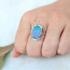 Split Band Sterling Silver Ring With Aurora Opal, Bold Oval Shape Engagement Ring, Women's Birthday Gift For Her Opal is a mesmerizing gemstone known for its iridescent play-of-color, which gives it a unique and captivating appearance. The term "Aurora Opal" could refer to any opal displaying a stunning array of colors reminiscent of the Northern or Southern Lights (Aurora Borealis or Aurora Australis). These opals often exhibit a brilliant interplay of colors when viewed from different angles. Silver Oval Ring For Birthday, Nickel Free Oval Opal Ring For Anniversary, Oval Opal Birthstone Ring For Gift, Handmade Oval Opal Ring For Anniversary, Adjustable Oval Opal Ring For Gifts, Aurora Opal, Aurora Australis, Southern Lights, Friendship Day Gifts