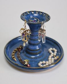 a blue vase with some jewelry on it