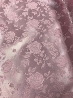 the fabric is pink and has flowers on it