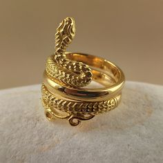 Snake ring made of 18 carat solid yellow gold Snake was the symbol of health in ancient Greece It's made with detailed handmade workmanship Made in Greece in our workshop in Athens A beautiful piece of jewelry that can be an unique gift for any special occasion For more information don't hesitate to contact us SHIPPING INFORMATION FREE SHIPPING VIA DHL EXPRESS Please fill in an active phone number It's required by the courier company DELIVERY TIME INFORMATION 1 - 3 Days EUROPE 3 - 5 Days to U.S. Gold Open Ring Hand Forged, Gold Hand Forged Open Ring, Hand Forged Gold Open Ring, Hand-forged Gold Open Ring, Luxury Carved Yellow Gold Signet Ring, Yellow Gold Symbolic Carved Jewelry, Carved Symbolic Yellow Gold Jewelry, Symbolic Yellow Gold Engraved Brass Ring, Traditional Carved Yellow Gold Rings