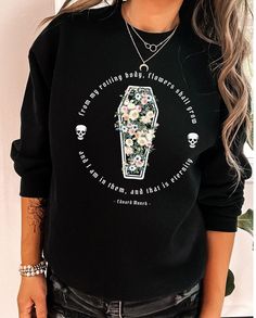 "This trendy goth sweatshirt features the quote by Edvard Munch, \"From my rotting body flowers shall grow, and I am in them and that is eternity,\" Perfect for those beautifully morbid vibes! Gildan sweatshirts are UNISEX SIZES and have a traditional, loose fit. Size up for that trendy oversized look! Medium-heavy fabric gives this sweatshirt beautiful drape and body. We recommend laying a favorite top flat and measuring it before ordering to get the perfect fit. PLEASE WASH BEFORE WEARING - items may feel slightly stiff when you receive them. This is normal due to the direct to garment printing process. Please wash to reveal the true softness of your new favorite piece! *:･ﾟ･ﾟ DETAILS *:･ﾟ･ﾟ This is a direct to garment print, no vinyl or stencils. Which means it will last a lot longer! T Emo Letter Print Sweatshirt For Fall, Black Emo Sweatshirt With Letter Print, Emo Sweatshirt With Letter Print And Crew Neck, Emo Crew Neck Sweatshirt With Letter Print, Emo Style Crew Neck Sweatshirt With Letter Print, Black Gothic Sweatshirt With Graphic Print, Alternative Halloween Sweatshirt With Letter Print, Alternative Style Letter Print Crew Neck Sweatshirt, Alternative Crew Neck Sweatshirt With Letter Print