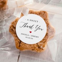 two cookies in plastic wrappers with a thank you tag