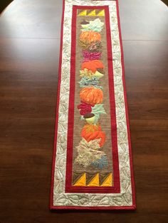 a long table runner with many pumpkins on it