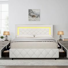 a white bed sitting in a bedroom next to two nightstands