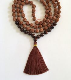 "Rudraksha and Red Tigers Eye Mala Necklace - 108 + 1 beads Mala Necklace in hand knotted mala with tassel. The Combination of Rudraksha and Red Tigers Eye makes the Mala look beautiful as both are Powerful Natural elements - Gifts of Nature to us. Rudraksha have been traditionally used as prayer beads. They are associated with Lord Shiva and the name Rudraksha translates to the Shiva's tears. They commonly worn by his devotees. They are worn as a form of protection as they have unique vibration Rudraksha Mala, Knotted Mala, Beads Mala, Tigers Eye Necklace, Mens Necklace, Red Tigers Eye, Yoga Jewelry, Mala Necklace, Natural Elements