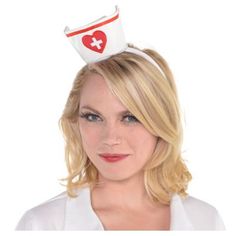 a woman wearing a white hat with a red heart on it's top and a cross on the side