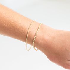 The beaded texture is a customer favorite to layer into a Yearly stack. Now you can choose a mini texture to mark a special year or just mix up your collection! A 2mm scalloped solid 14k gold bangle. 14k Gold Beaded Bracelets With Tiny Beads, Elegant Round Beads Bracelets For Layering, Dainty Stackable Yellow Gold Bracelet, Minimalist Single Strand Gold Bracelet, Stackable Yellow Gold Beaded Bracelets For Everyday, Dainty Stackable Beaded Bracelets In 14k Gold, Everyday Stackable Yellow Gold Beaded Bracelet, Dainty Stackable 14k Gold Beaded Bracelets, 14k Gold Bracelets With Tiny Round Beads