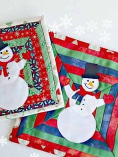 two quilted snowmen sitting next to each other