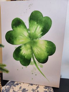 a painting of a green four leaf clover