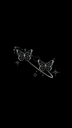 two butterflies flying in the dark with stars