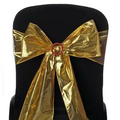 the back of a black chair with gold ribbon on it