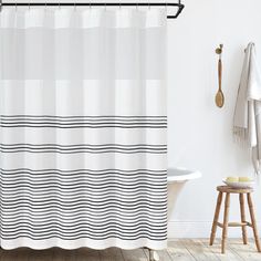 a white shower curtain with black and white stripes