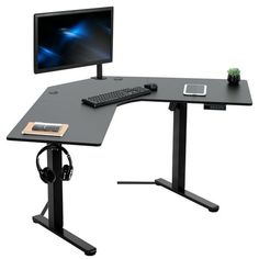 a computer desk with a monitor, keyboard and headphones on top of it in front of a white background