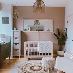 a baby's room with a white crib, chair and rug on the floor