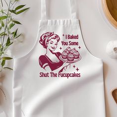 a white apron that says i baked you some shut the cupcakes on it