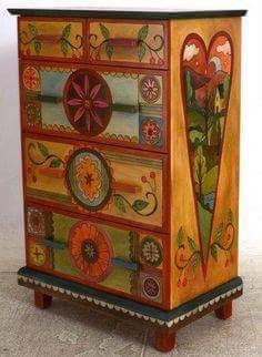 an artisticly painted chest of drawers with flowers