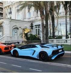 two orange and blue lambs parked in front of a house