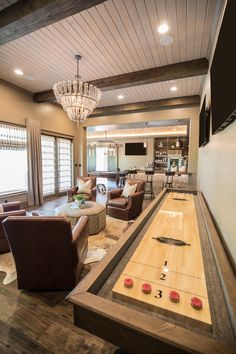 a living room filled with furniture and a bowling table