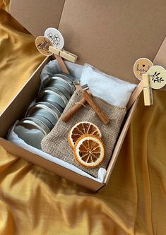 an open box with silverware and orange slices