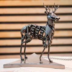 a metal deer sculpture sitting on top of a table