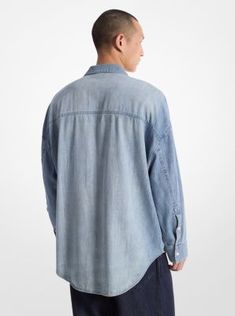 An essential addition to the season’s casual-cool wardrobe, this oversized take on the classic chambray shirt is as comfortable as it is versatile. Made from soft, breathable, 100% cotton, the button-up shirt features flap pockets, a drop shoulder and knuckle-grazing cuffs. The perfect way to lend a utilitarian edge to any look, it will work with everything from tailored separates to denim. Medium Wash Relaxed Fit Button-up Shirt, Casual Tops With Roll-up Sleeves And Shirttail Hem, Light Wash Oversized Tops For Everyday, Oversized Light Wash Tops For Everyday, Relaxed Fall Shirt For Everyday Wear, Relaxed Everyday Shirt For Fall, Relaxed Everyday Fall Shirt, Casual Oversized Shirt With Flap Pockets, Relaxed Fit Medium Wash Top For Fall