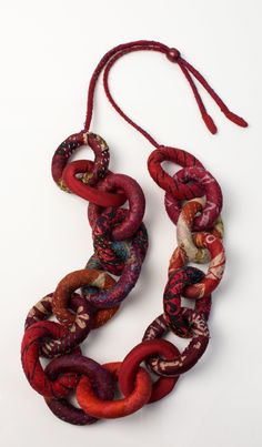 Silk Kantha Convertible Chain Necklace by Mieko Mintz . A chain necklace unlike any other! Exaggerated links are sewn from vintage silk saris and finished with kantha stitching. The silk cord adjusts to be worn long, as shown, or short, like a choker. Each is unique, and colors and patterns will vary. Limited quantities available. Fiber Art Jewelry, Silk Necklace, Diamond Cross Necklaces, Necklace Ideas, Fiber Jewelry, Fabric Necklace, Creation Couture, Gold Bracelets, Solitaire Necklaces