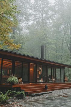 a house in the woods on a foggy day