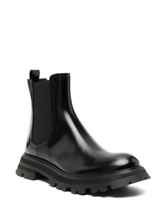 Wander Chelsea leather boots from Alexander McQueen featuring black, calf leather, elasticated side panels, round toe, slip-on style, pull-tab at the heel and chunky rubber lug sole. Size Info IT Color Detail Black Made In Italy Material Lining: Calf Leather 100% Outer: Patent Calf Leather 100%, Fabric 100% Sole: Rubber 100% Season One Fall-Winter Season Two Fall-Winter Product boots Brand Alexander Mcqueen Size And Fit Heel 1,8 in / 4,5 cm; Platform 1,2 in / 3 cm Black Chelsea Boots With Lug Sole In Calf Leather, Black Calf Leather Chelsea Boots With Lug Sole, Chelsea Leather Boots, Alexander Mcqueen Boots, Planet People, Travel Tote Bag, Trench Jacket, Crossbody Tote Bag, Moon Boots