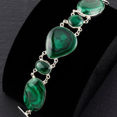 Inspired by the natural beauty and healing properties of malachite, this bracelet combines the vibrant energy of the gemstone with the timeless elegance of sterling silver. Adorned with multiple genuine malachite stones, each showcasing the stone's unique, vibrant green patterns. Ideal for those who love bold and eye-catching jewelry. Gemstone - Genuine Malachite 925 Sterling silver Adjustable from 7" to 8.5" L  Handmade in Taxco, Mexico Spiritual Malachite Bracelet Jewelry, Malachite Gemstone Bracelet, Green Sterling Silver Bracelet With Natural Stones, Elegant Handmade Malachite Bracelets, Malachite Bracelets With Natural Stones, Green Sterling Silver Bracelet With Polished Finish, Green Sterling Silver Bracelets With Polished Finish, Elegant Malachite Bracelet Jewelry, Elegant Malachite Bracelet