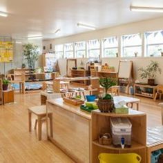 a classroom filled with lots of wooden furniture and desks covered in bookshelves