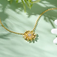 The sunflower with its beautiful fluttering petals and contrasting colors reminds us of summer sun and happy times. In this necklace we have chosen to focus on the flower’s built-in contrast. We do this by placing a multitude of small brown  and white stones in the center and letting them play up against a wreath of curved gold leaves. The beautiful sunflower design is sure to brighten up any outfit, and the quality materials make it perfect for everyday wear.Carat Weight: 0.659 ctStone Size: 1. Elegant Sunflower Design Necklaces As Gift, Elegant Necklaces With Sunflower Design For Gifts, Elegant Sunflower Design Necklace For Gift, Elegant Sunflower Design Necklaces For Gift, Elegant Sunflower Design Flower Necklace, Elegant Sunflower Design Flower Pendant Jewelry, Elegant Necklace With Sunflower Pendant, Meaning Of Sunflower, Yellow Flower Pendant Necklace With Sunflower Design