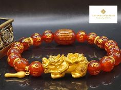 Gift yourself or your loveonce this beautiful Pure Gold Pixiu Bracelet.  *Materials: Au999 Pure Gold and Carnelian Stone.  *Karat: 24K Pure Gold  *Gold Color: Yellow *Gold Weight: Approximately 3.75g 🔸️Pi Xiu has the meaning of bringing in wealth and treasure. Of course, it is capable of warding off evil spirits and bringing good fortune.  OUR 24K GOLD IS MADE FROM 5G TECHNOLOGY What does 5G mean? 1, Grace : toughness, not easy to break 2, Gusty : light weight, high hardness 3, Genius : advanced technology, style fashion 4, Glorious : never fades 5, Gentle : high purity, full gold 999. Metal is made of real 24K Gold Only. Not gold filled. Not gold vermeil. Not gold plated . STAMPED 📬S H I P P I N G WE SHIP WITHIN 24 HOURS. Free shipping in the  US and International Spiritual Yellow Gold Beaded Bracelets As Gift, Spiritual Gold Bracelet With Round Beads As Gift, Gold Beaded Bracelets For Wedding And Valentine's Day, Traditional Rose Gold Bangle As Gift, Gold Crystal Bracelet For Valentine's Day Gift, Elegant Bracelets For Festivals Gift, Elegant Bracelets For Festivals And Gifts, Elegant Festival Bracelets As Gift, Flexible Beaded Bracelets As A Gift