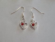 "Cute Red Rhinestone Heart Earrings. They measure  approx: 13x12mm(1/2\"x1/2\"), and are made of zinc metal  alloy (lead and nickel safe), and red rhinestones. They are attached to silver plated ear wires which measure 19mm x  18mm (7/8\"  x 7/8\"), and come packaged in a pretty organza bag to keep them in, or for gift giving." Rhinestone Heart, Red Earrings, Red Rhinestone, Organza Bags, Heart Earrings, Red Heart, Ear Wires, Jewelry Earrings Dangle, Etsy Earrings