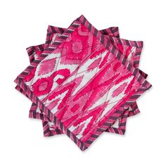 four pink and white napkins stacked on top of each other, with an abstract design