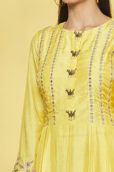 Mango kurta with floral embroidery on bodice and sleeve hem. Paired with palazzo and dupatta.
Component: 3
Pattern: Embroidery
Type Of Work: Floral
Neckline: Round
Sleeve Type: Bell sleeves
Fabric: Kurta, Palazzo- Cotton Silk, Dupatta- Weaving 
Color: Yellow
Other Details: 
Box pleat kurta
Bird embellished placket
Closure: Palazzo: Front zipper
Occasion: Sangeet - Aza Fashions Kurta Embroidery, Yellow Kurta, Kurta Palazzo Set, Desi Wear, Kurta Palazzo, Palazzo Set, Embroidery Floral, Pattern Embroidery, Silk Dupatta