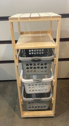 three baskets stacked on top of each other in front of a shelf with two bins