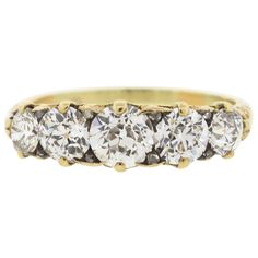 Antique Victorian diamond five stone ring set in 18k yellow gold circa 1880. The ring is set with five Old European cut diamonds, and accented by small rosecut diamonds. The total diamond weight is approximately 2.30 carats total. The diamonds are estimated to be H to I color and VS clarity. The ring is a nice full looking band, and is lovely on its own or worn with other rings. There is beautiful scroll work along the sides of the ring. It is a size 8.75. Victorian Diamond Ring, Scroll Work, Victorian Rings, Stone Engagement Rings, European Cut Diamonds, Rose Cut Diamond, Antique Victorian, Stone Ring, Stone Rings