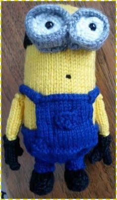 a crocheted minion with glasses on it's head and overalls