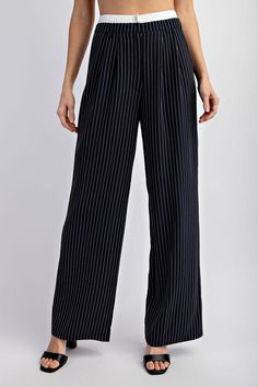 Model is wearing Navy Pinstriped Tailored Trousers and black heels, close view of the pants showing the white elastic waist hem Swimwear Sale, Tailored Trousers, Polished Look, Navy White, Navy And White, Woven Fabric, Elastic Waist, Trousers, Spandex