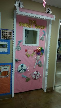 a pink door decorated with pictures and decorations