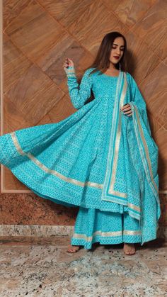 Anarkali Palazzo Set With Block Print And Long Sleeve, Blue Long Sleeve Cotton Anarkali Set, Cotton Anarkali Sharara With Zari Work, Cotton Anarkali Set With Zari Work, Anarkali Sharara With Zari Work, Cotton Sharara For Designer Wear, Transitional Season, Blue Anarkali Set In Mulmul Fabric, Blue Anarkali Salwar Kameez In Mulmul, Blue Cotton Anarkali Set With Cutdana