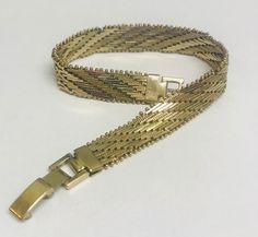 Elegant 1960s era Milanese bracelet with partial gold plating. It is approximately 8 inches long and has a fold over clasp. Excellent condition