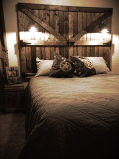 a bed with two pillows on top of it and a headboard made out of wooden planks