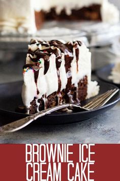 a slice of brownie ice cream cake on a black plate with a fork in front of it