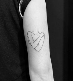 a black and white photo of a woman's arm with a tattoo on it