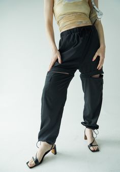 It doesn't get more functional than the Double Take Utility Pant. One minute they're the chicest, most comfortable activewear pant of your dreams, and the next they're your favorite high waisted active shorts. The pants feature two cargo pockets, hidden zippers for a seamless transition into shorts, and adjustable ankles to make it as easy as possible to slip the bottom half off over your sneakers. Running from afternoon workout to a fun happy hour with friends? Ditch the sneakers, cinch the adj Sporty High-stretch Bottoms With Pockets, Functional High Stretch Bottoms With Side Pockets, High Stretch Functional Bottoms With Side Pockets, High Stretch Functional Pants With Pockets, Functional High Stretch Pants With Pockets, Sporty Stretch Cargo Pants With Drawstring, Sporty Stretch Cargo Pants With Functional Drawstring, Functional Black Cargo Bottoms, Functional Black Cargo Style Bottoms