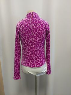 "We are so excited for this new shirt but we have limited stock! Sparkly glitter and fun leopard print will surely set you apart from the crowd! Available in Fuchsia and Lime Green. Shirt stretches for extra comfort and fit. Zip back and our signature attached brief with velcro closure to stay tucked in. Merchandise is shipped within 1 to 3 weeks. If a rush order is needed , message us here, or e-mail us at gloria [!at] rodeoqueenshirts.com to check availability. We try to keep 1 of every shirt Fitted Printed Purple Tops, Leopard Print Stretch Tops For Spring, Spring Leopard Print Stretch Top, Spring Stretch Leopard Print Tops, Trendy Leopard Print Tops For Party, Trendy Long Sleeve Leopard Print Top, Fitted Leopard Print Tops For Spring, Fitted Trendy Purple Shirt, Trendy Fitted Purple Shirt